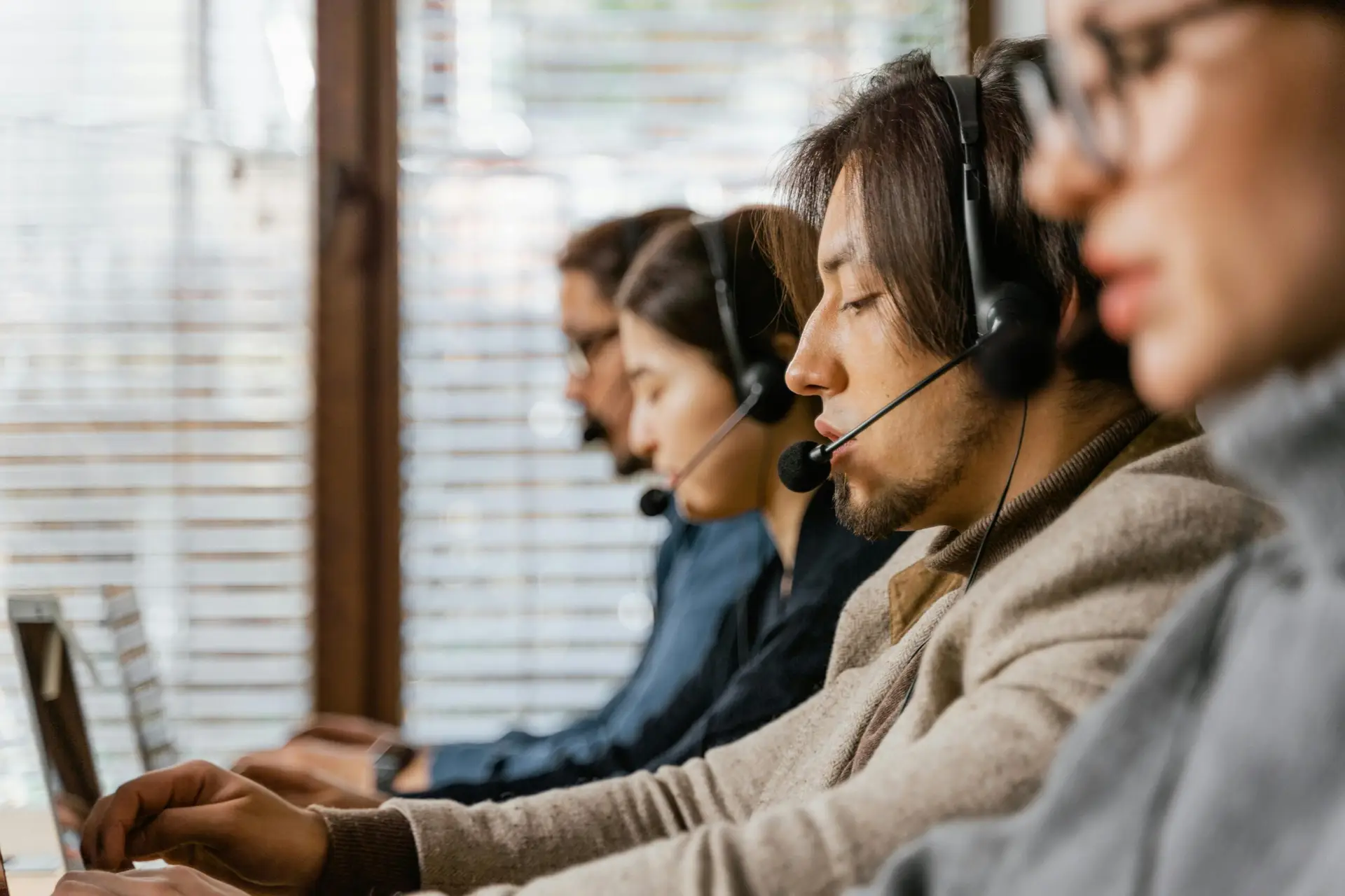 Call center employees working diligently with headsets, offering dedicated customer service.